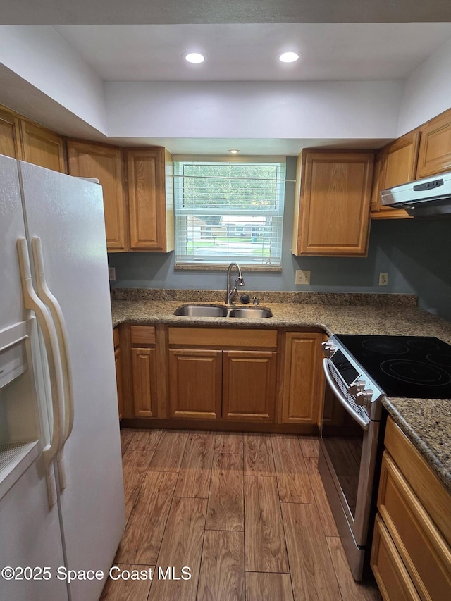 744 John Carroll Ln, Melbourne, FL 32904 - kitchen featuring white fridge with ice dispenser, electric range, ventilation hood, wood finished floors, and brown cabinetry