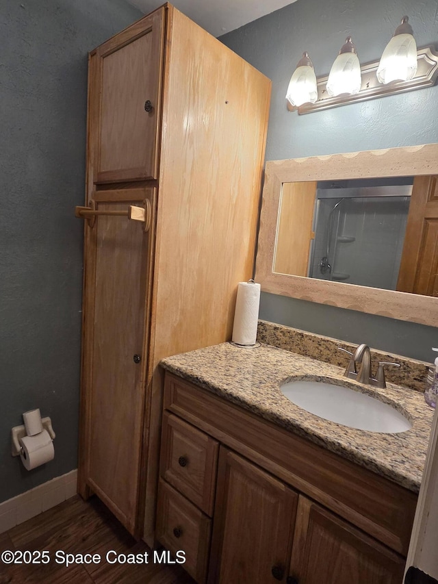 744 John Carroll Ln, Melbourne, FL 32904 - full bathroom with vanity, wood finished floors, and a shower