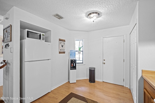 3375 Bryce St, Cocoa, FL 32926 - entryway featuring light wood-style flooring and a textured ceiling