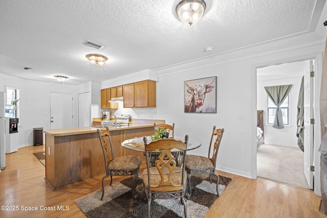 3375 Bryce St, Cocoa, FL 32926 - dining area featuring a textured ceiling and light wood-type flooring
