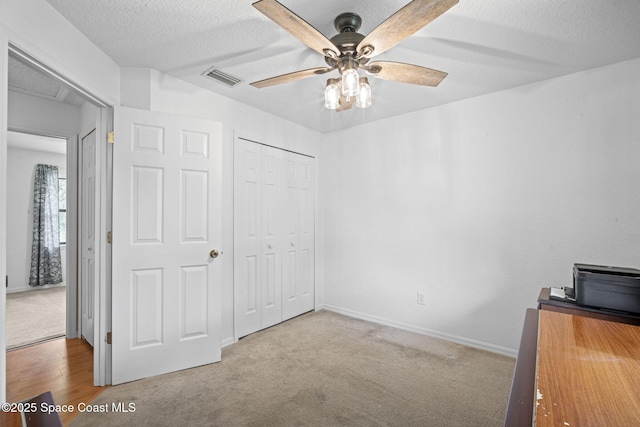 3375 Bryce St, Cocoa, FL 32926 - unfurnished bedroom featuring a closet, a textured ceiling, carpet flooring, and a ceiling fan