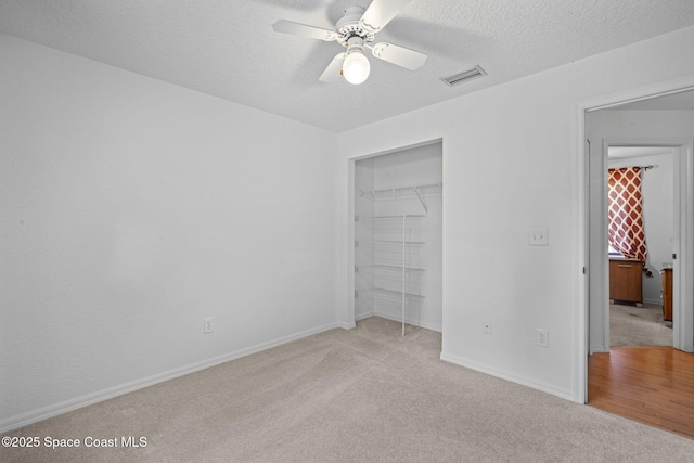 3375 Bryce St, Cocoa, FL 32926 - unfurnished bedroom with carpet, a closet, a textured ceiling, and a ceiling fan