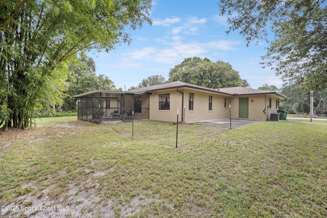 3375 Bryce St, Cocoa, FL 32926 - rear view of house featuring a sunroom, stucco siding, and a yard
