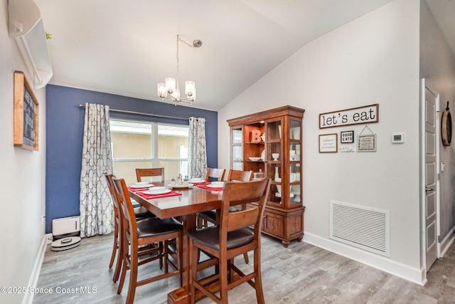 711 Tupelo Cir, Cocoa, FL 32926 - dining room featuring lofted ceiling, a chandelier, and wood finished floors
