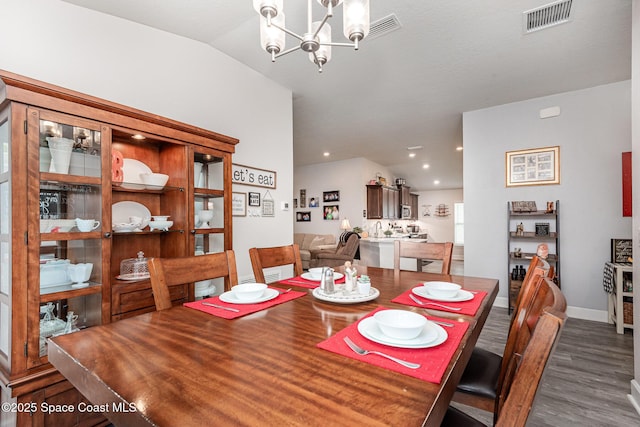 711 Tupelo Cir, Cocoa, FL 32926 - dining area with wood finished floors, a chandelier, lofted ceiling, and recessed lighting