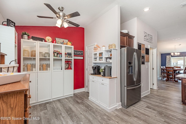 711 Tupelo Cir, Cocoa, FL 32926 - kitchen with stainless steel refrigerator with ice dispenser, light wood-style flooring, ceiling fan, light countertops, and lofted ceiling