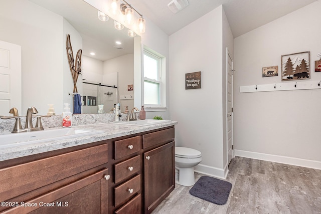 711 Tupelo Cir, Cocoa, FL 32926 - bathroom with double vanity, wood finished floors, and a stall shower
