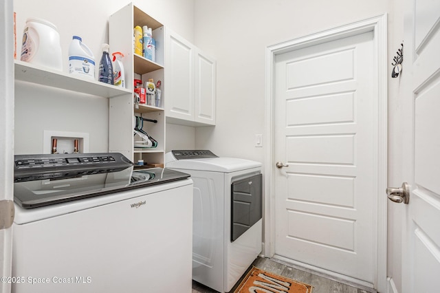 711 Tupelo Cir, Cocoa, FL 32926 - washroom featuring cabinet space, washing machine and clothes dryer, and light wood-style floors