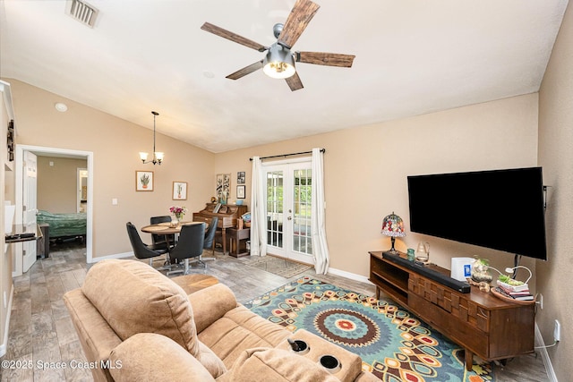 6355 Betty Ave, Cocoa, FL 32927 - living area featuring wood finished floors, vaulted ceiling, ceiling fan, french doors, and a chandelier