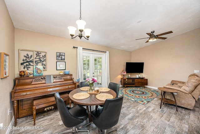 6355 Betty Ave, Cocoa, FL 32927 - dining space with wood finished floors, vaulted ceiling, a chandelier, and a ceiling fan