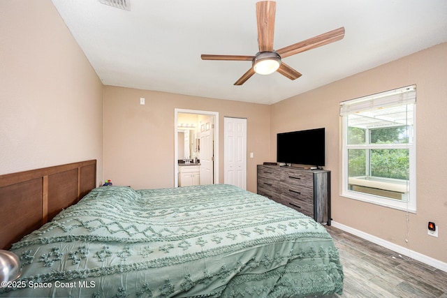 6355 Betty Ave, Cocoa, FL 32927 - bedroom featuring wood finished floors, ensuite bath, and ceiling fan