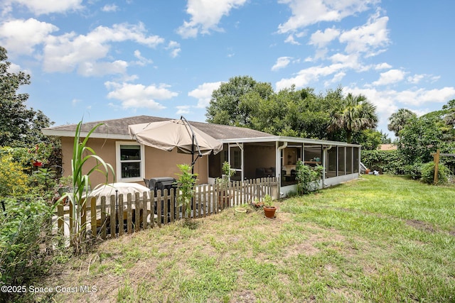 6355 Betty Ave, Cocoa, FL 32927 - back of house featuring a sunroom, stucco siding, and a shingled roof