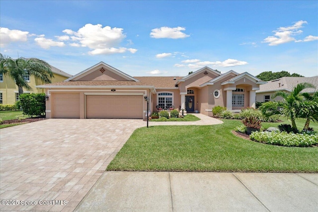 3616 Peninsula Cir, Melbourne, FL 32940 - mediterranean / spanish-style house featuring stucco siding, driveway, an attached garage, and a front lawn