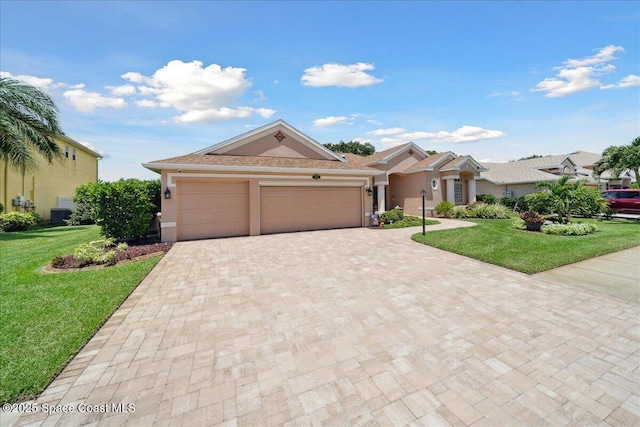 3616 Peninsula Cir, Melbourne, FL 32940 - view of front of home featuring a garage, stucco siding, decorative driveway, and a front lawn