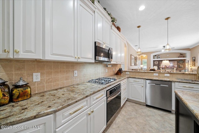 3616 Peninsula Cir, Melbourne, FL 32940 - kitchen featuring stainless steel appliances, tasteful backsplash, white cabinetry, and pendant lighting