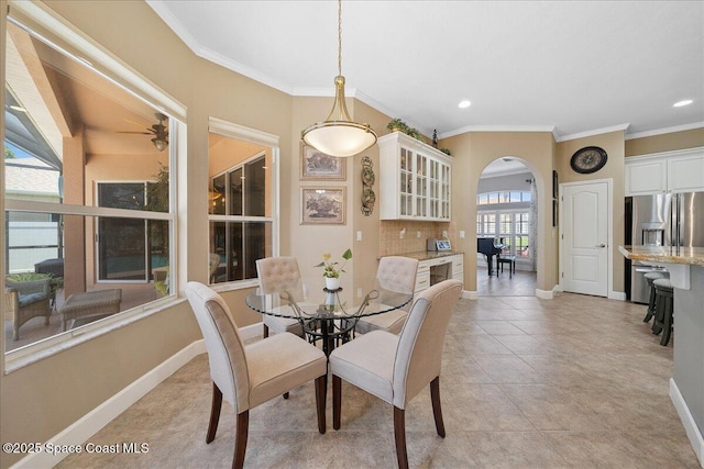 3616 Peninsula Cir, Melbourne, FL 32940 - dining space with arched walkways, ornamental molding, recessed lighting, and light tile patterned flooring