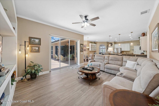 3616 Peninsula Cir, Melbourne, FL 32940 - living area with ceiling fan, light wood-style floors, ornamental molding, plenty of natural light, and recessed lighting