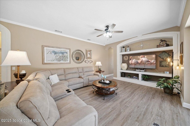 3616 Peninsula Cir, Melbourne, FL 32940 - living area featuring built in features, arched walkways, wood finished floors, ceiling fan, and crown molding