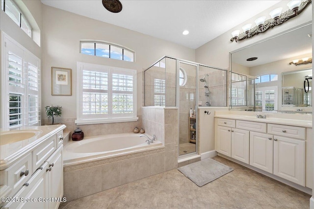 3616 Peninsula Cir, Melbourne, FL 32940 - full bathroom featuring two vanities, a garden tub, a stall shower, and tile patterned flooring