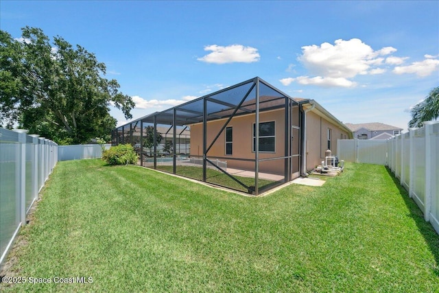 3616 Peninsula Cir, Melbourne, FL 32940 - rear view of property with a fenced backyard, stucco siding, and glass enclosure