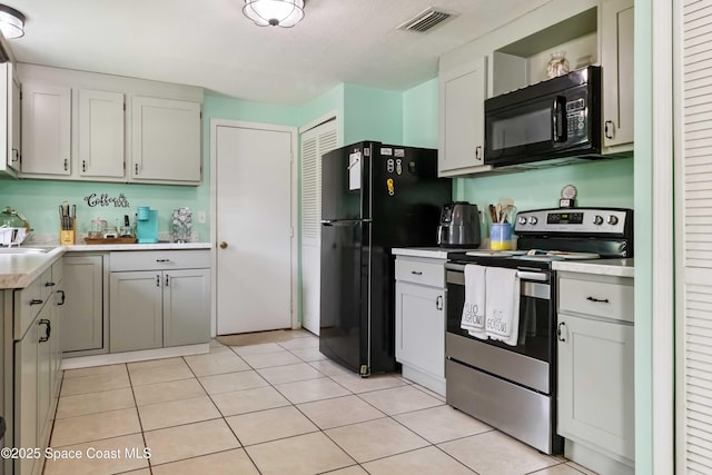 542 Troy Rd SW, Palm Bay, FL 32908 - kitchen featuring black appliances, light countertops, light tile patterned flooring, and open shelves