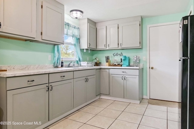 542 Troy Rd SW, Palm Bay, FL 32908 - kitchen with light countertops, freestanding refrigerator, and light tile patterned flooring