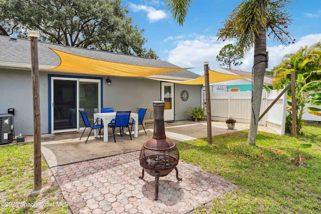 542 Troy Rd SW, Palm Bay, FL 32908 - rear view of house featuring stucco siding, a fire pit, a patio area, and roof with shingles
