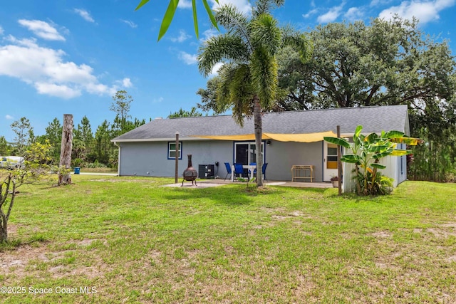 542 Troy Rd SW, Palm Bay, FL 32908 - back of house with a patio area, stucco siding, and a lawn