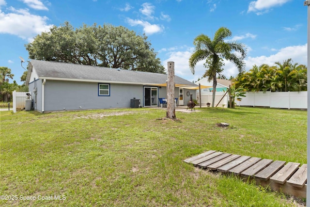 542 Troy Rd SW, Palm Bay, FL 32908 - back of house with stucco siding, a fenced backyard, and a patio area