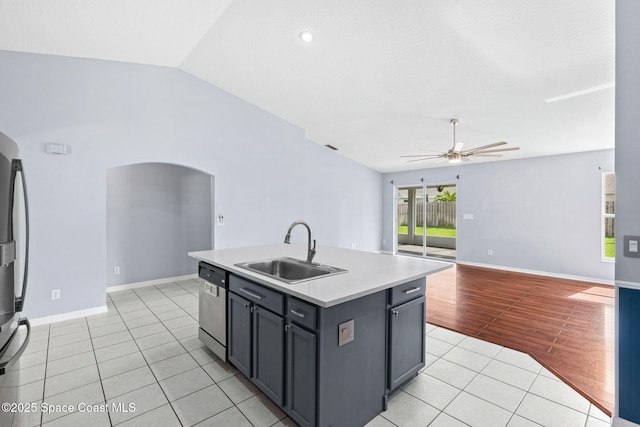 1493 Laramie Cir, Melbourne, FL 32940 - kitchen featuring stainless steel dishwasher, a ceiling fan, arched walkways, light tile patterned floors, and open floor plan