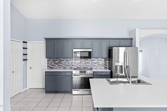 1493 Laramie Cir, Melbourne, FL 32940 - kitchen with stainless steel appliances, light countertops, light tile patterned floors, tasteful backsplash, and gray cabinets