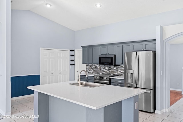 1493 Laramie Cir, Melbourne, FL 32940 - kitchen with appliances with stainless steel finishes, light tile patterned flooring, vaulted ceiling, light countertops, and backsplash