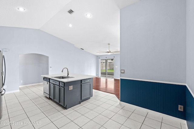 1493 Laramie Cir, Melbourne, FL 32940 - kitchen featuring a ceiling fan, arched walkways, lofted ceiling, light tile patterned flooring, and open floor plan