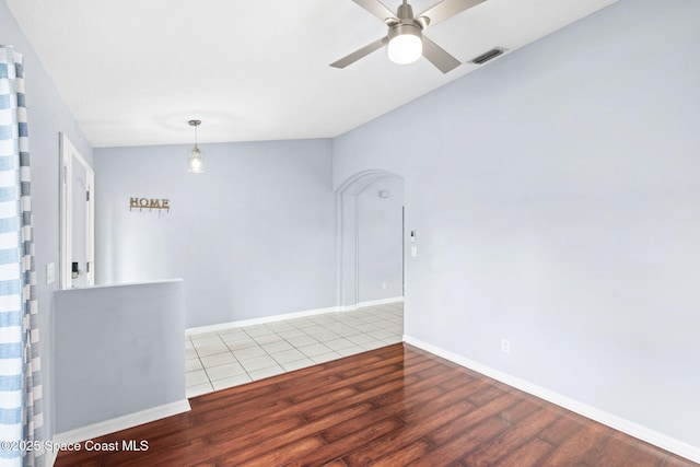 1493 Laramie Cir, Melbourne, FL 32940 - spare room featuring wood finished floors, a ceiling fan, and arched walkways