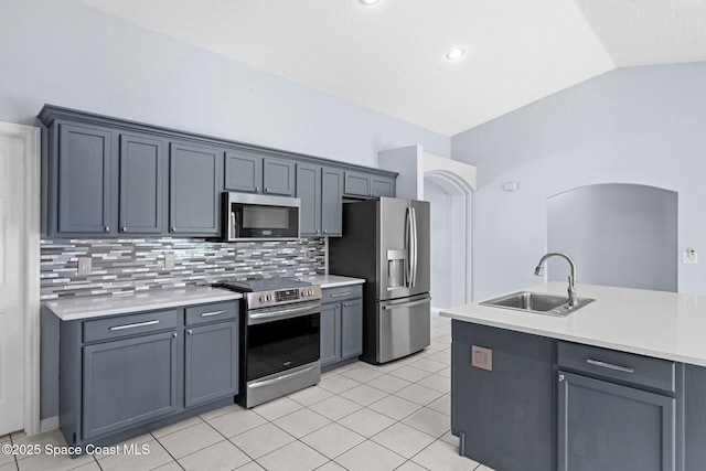 1493 Laramie Cir, Melbourne, FL 32940 - kitchen with appliances with stainless steel finishes, lofted ceiling, light countertops, decorative backsplash, and light tile patterned flooring