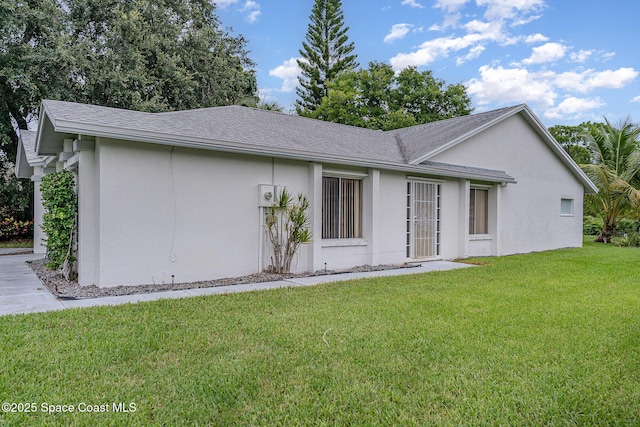 386 Myrtlewood Rd, Melbourne, FL 32940 - back of property featuring stucco siding, a yard, and roof with shingles