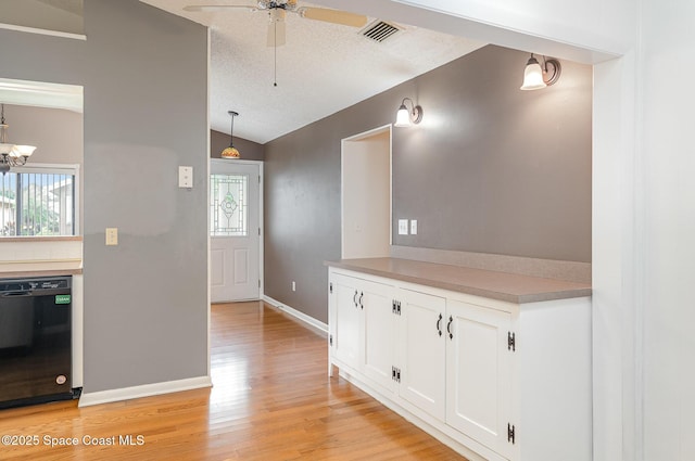 386 Myrtlewood Rd, Melbourne, FL 32940 - corridor with lofted ceiling, light wood-style flooring, plenty of natural light, and a textured ceiling