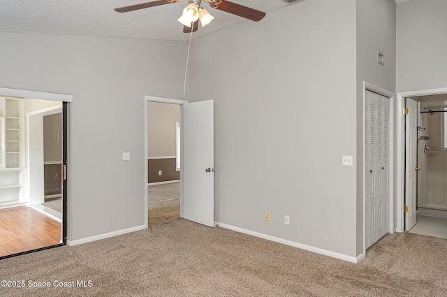 386 Myrtlewood Rd, Melbourne, FL 32940 - unfurnished bedroom featuring carpet, high vaulted ceiling, ensuite bathroom, and a ceiling fan