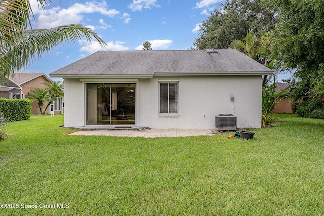 386 Myrtlewood Rd, Melbourne, FL 32940 - back of property with roof with shingles, stucco siding, a lawn, and a patio area