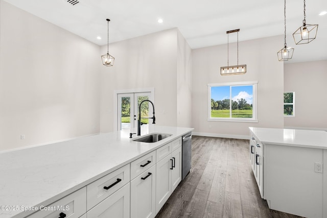 278 Stallion St, Palm Bay, FL 32909 - kitchen with stainless steel dishwasher, french doors, white cabinetry, pendant lighting, and plenty of natural light