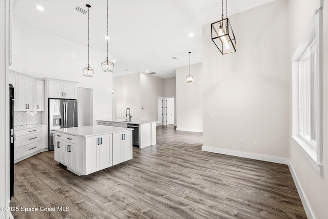 278 Stallion St, Palm Bay, FL 32909 - kitchen with stainless steel refrigerator with ice dispenser, an island with sink, dishwasher, open floor plan, and light countertops