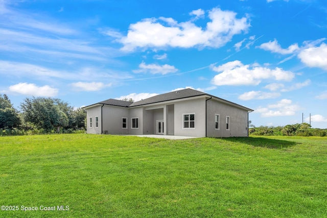 278 Stallion St, Palm Bay, FL 32909 - back of property featuring stucco siding, a yard, and a patio area