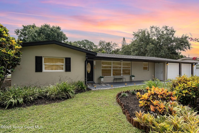 560 Conifer St, Melbourne, FL 32904 - single story home with a garage, a yard, stucco siding, and covered porch
