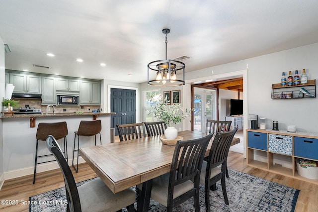 560 Conifer St, Melbourne, FL 32904 - dining room featuring a chandelier, light wood-style flooring, and recessed lighting