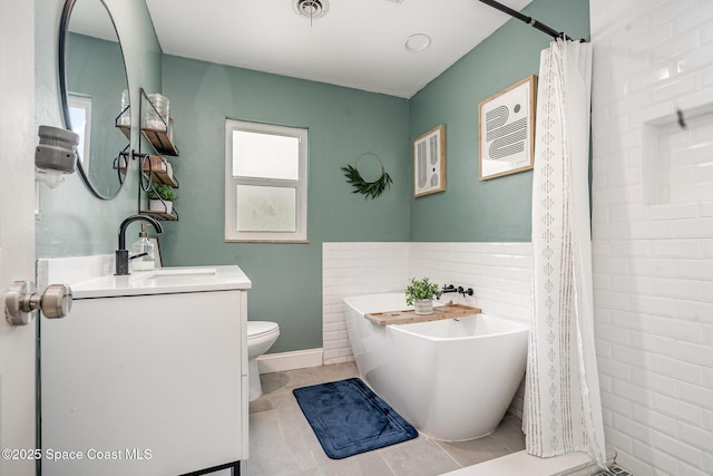 560 Conifer St, Melbourne, FL 32904 - full bath featuring vanity, a soaking tub, and tile patterned floors