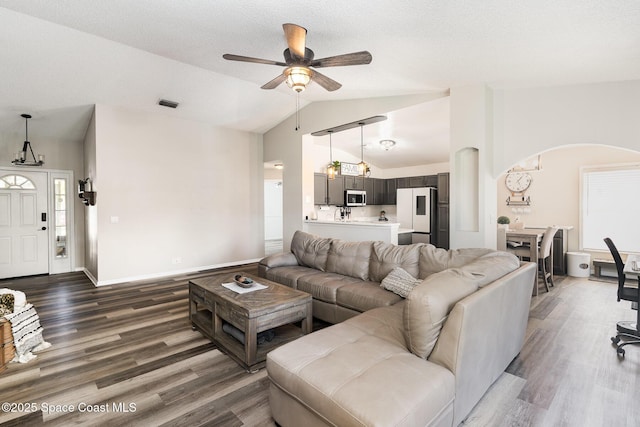 1519 Bronco Dr, Melbourne, FL 32940 - living room with lofted ceiling, wood finished floors, ceiling fan, and arched walkways