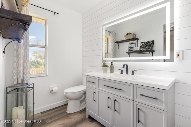1519 Bronco Dr, Melbourne, FL 32940 - bathroom featuring vanity, wood walls, and wood finished floors