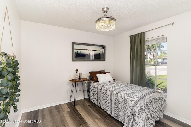 1519 Bronco Dr, Melbourne, FL 32940 - bedroom with wood finished floors, a chandelier, and a textured ceiling