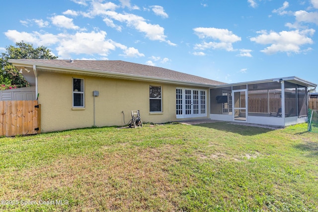 1519 Bronco Dr, Melbourne, FL 32940 - back of house with stucco siding, a sunroom, and french doors