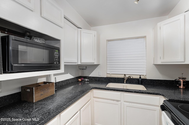 5600 N Banana River Blvd Unit 14, Cocoa Beach, FL 32931 - kitchen with black microwave, white cabinetry, and dark stone counters